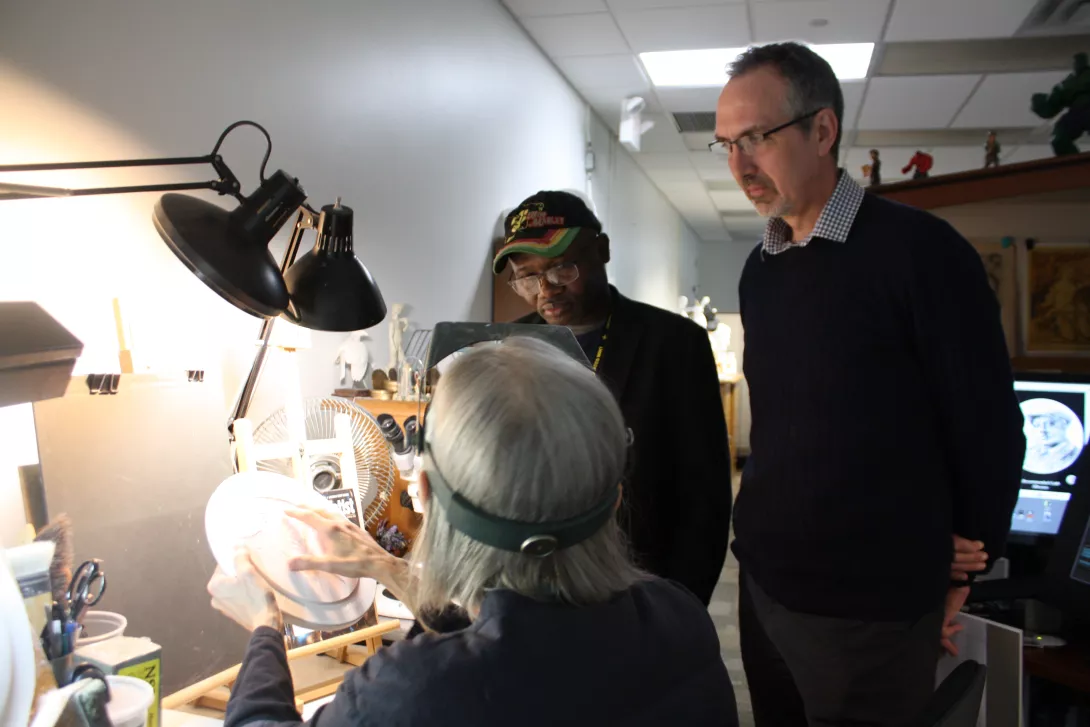 CCAC Members reviewing coins